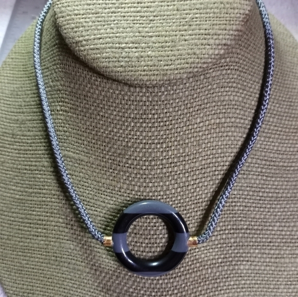 Vintage Jewelry - Goldtone gray black round donut pendant on gray cord necklace